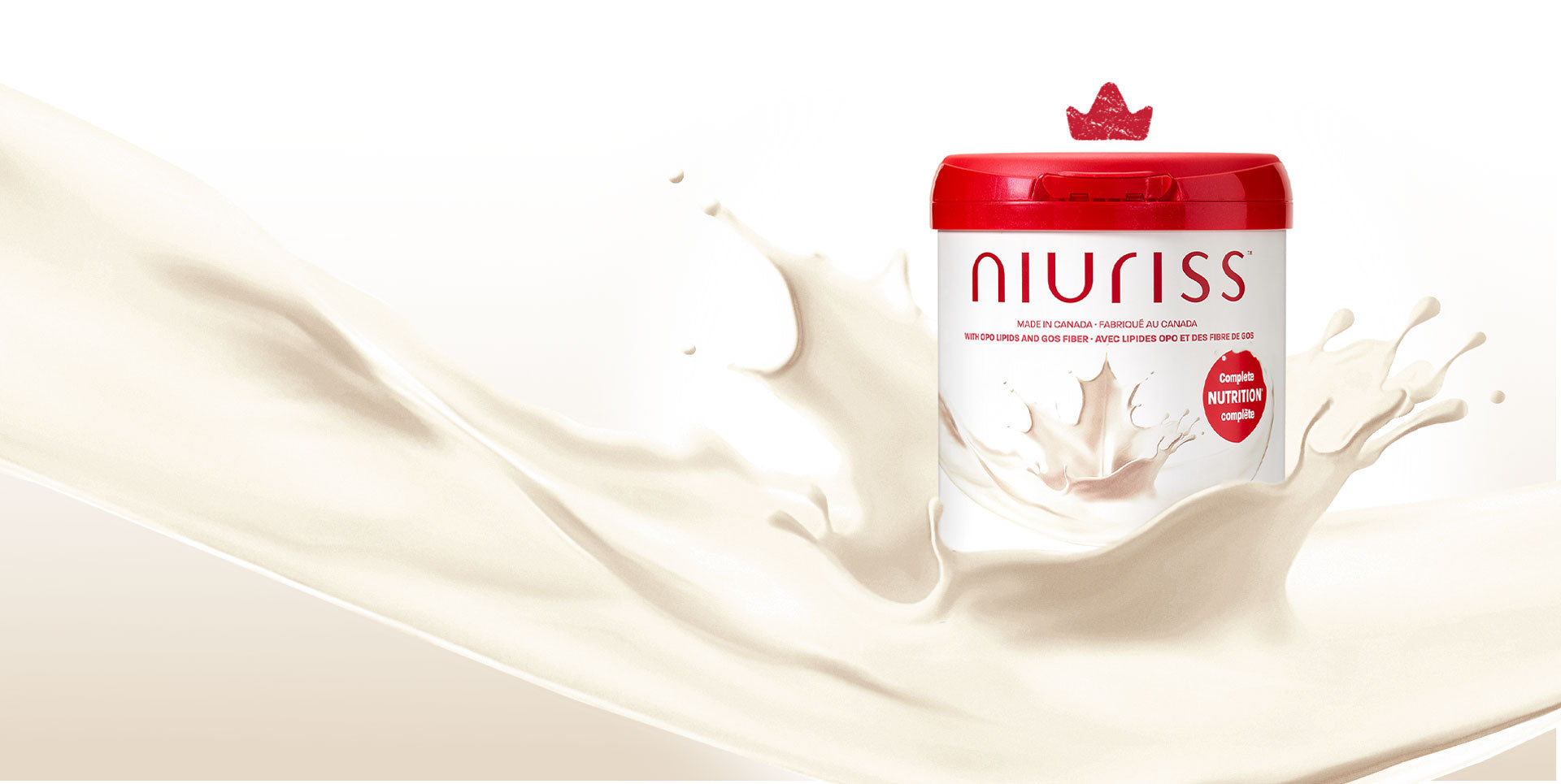 A can of Niuriss Infant Formula falls into a splash of milk. A crown hovers above it, representing our quality formulas.