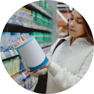 Mom checking the nutritional value of a milk at the back of the can in the grocery supermarket